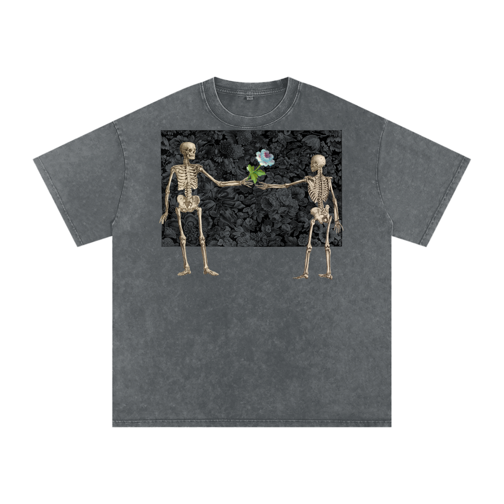 Gray t-shirt with a graphic of two skeletons exchanging a flower on a black background.